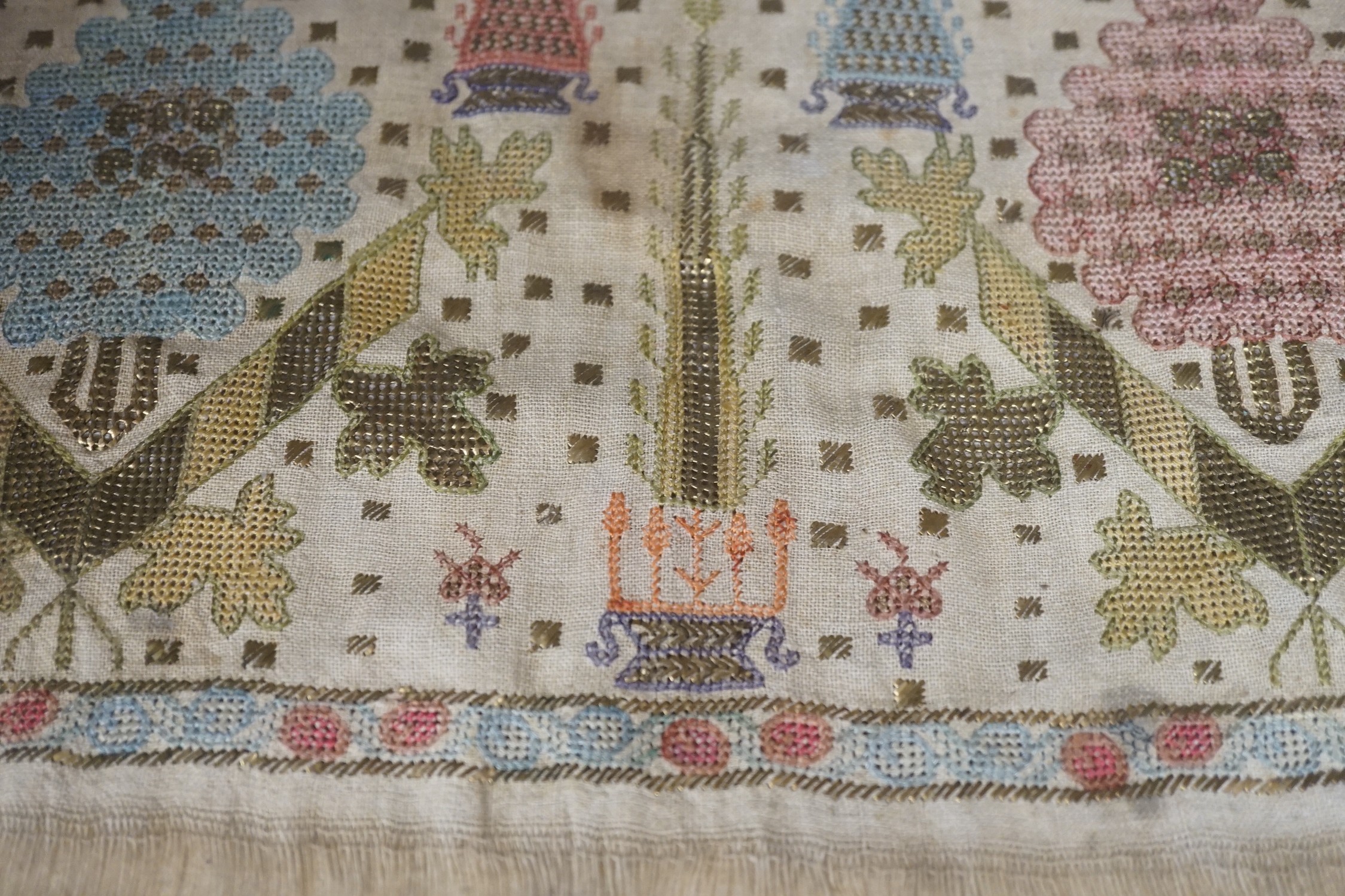 Two 19th century embroidered Turkish towel ends, one framed, 46cms wide x 30cms high